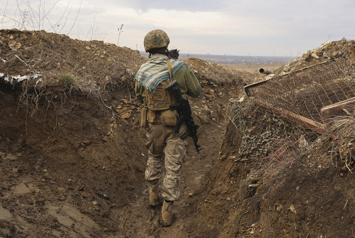 A Ukrainian soldier walks in a trench on the line of separation from pro-Russian rebels near Debaltsevo, Donetsk region, Ukraine, on 3 December 2021. Tensions between Russia and NATO members escalated in 2021 with Ukraine and a number of Western states becoming increasingly concerned that a Russian troop build-up near the Ukrainian border could signal Moscow’s intention to invade. Their fears were realized on 24 February 2022.