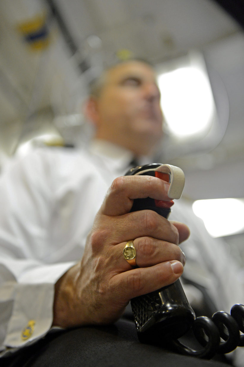A UK Weapons Engineer Officer's hand on a tactical trigger for the launching of Trident ballistic missiles.