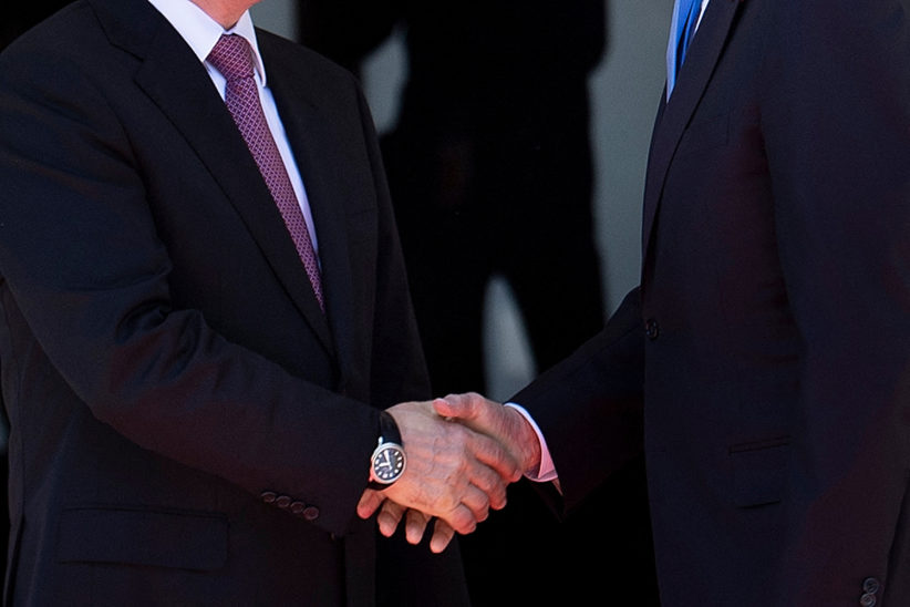 Russia’s President Vladimir Putin (left) and US President Joe Biden shake hands before their first  meeting, at Villa La Grange in Geneva, 16 June 2021.