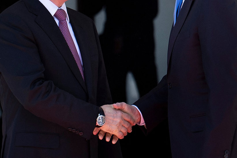 Russia’s President Vladimir Putin (left) and US President Joe Biden shake hands before their first meeting, at Villa La Grange in Geneva, 16 June 2021.