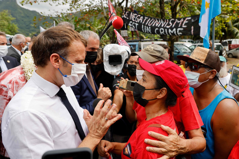France’s President Emmanuel Macron speaks with a victim of French nuclear tests during his visit to  Moorea island in July 2021.